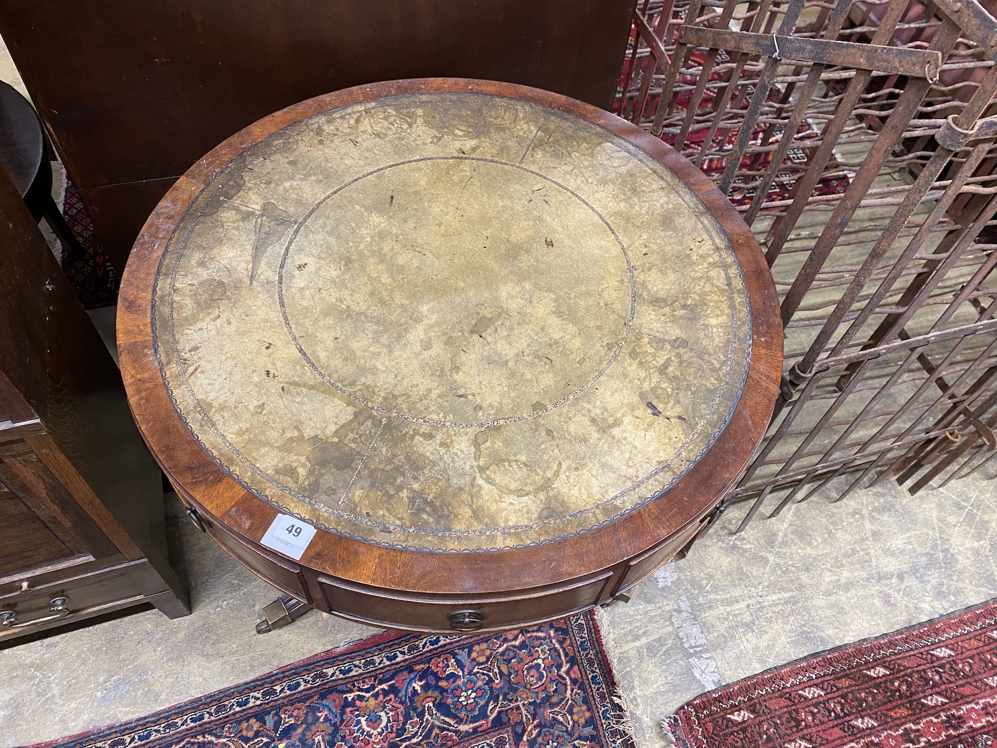A reproduction mahogany small drum table with tooled green leather top, diameter 76cm, height 71cm